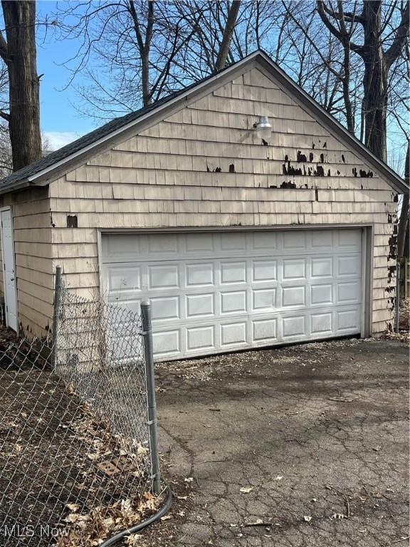 detached garage featuring fence