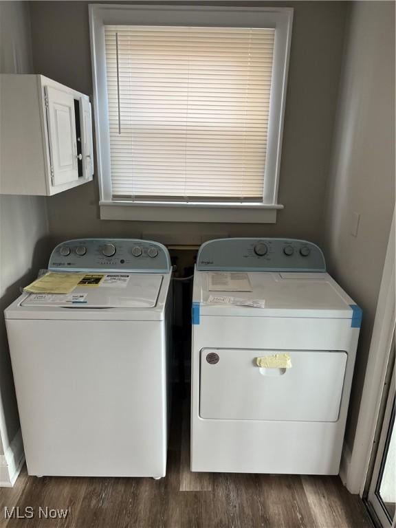 laundry area with dark wood-style floors, laundry area, and washer and clothes dryer