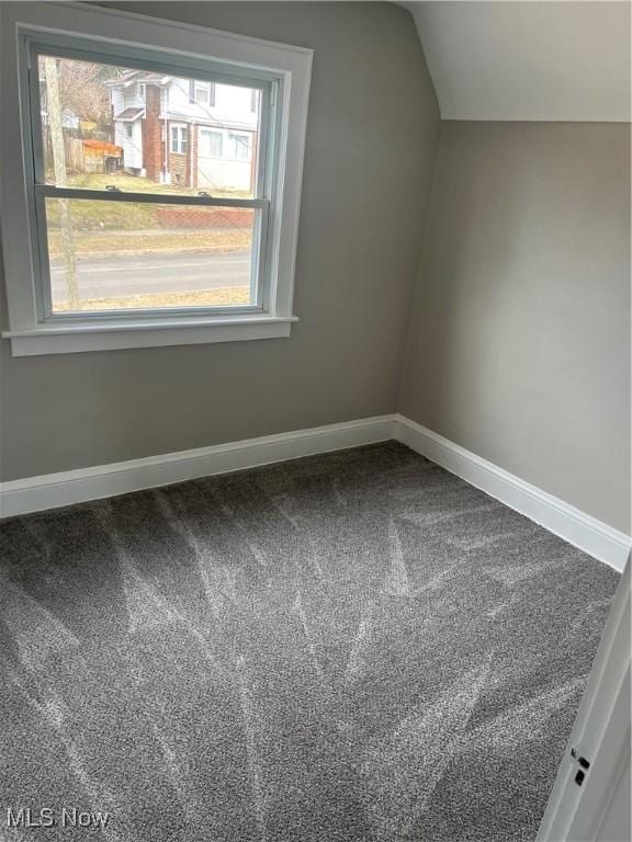 bonus room with lofted ceiling, carpet flooring, and baseboards