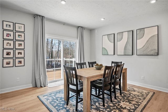 dining room featuring recessed lighting, a textured ceiling, baseboards, and wood finished floors