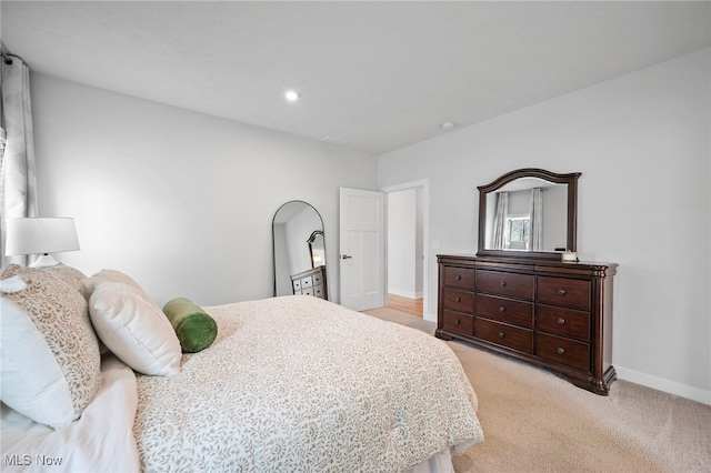 bedroom with light carpet, recessed lighting, and baseboards