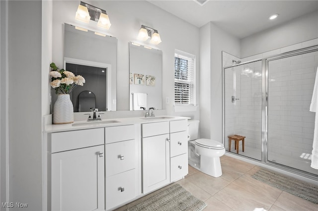 full bath featuring tile patterned floors, a sink, and a shower stall