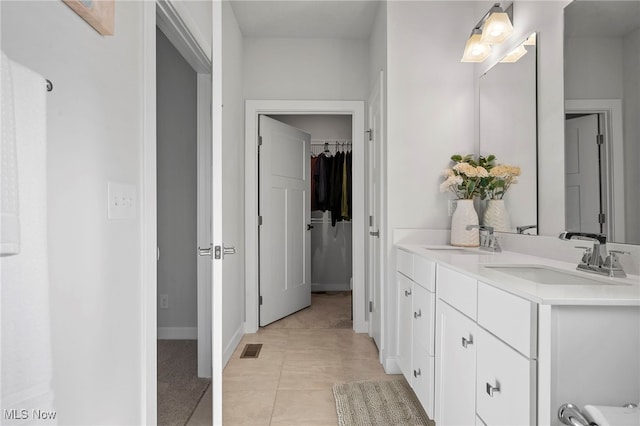 full bath with visible vents, baseboards, tile patterned flooring, a spacious closet, and vanity