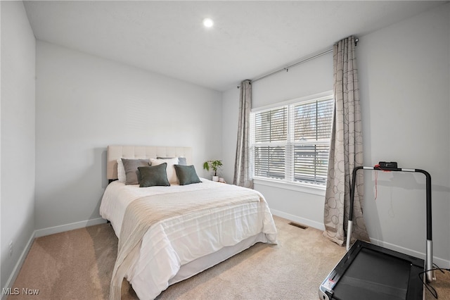 carpeted bedroom featuring visible vents and baseboards