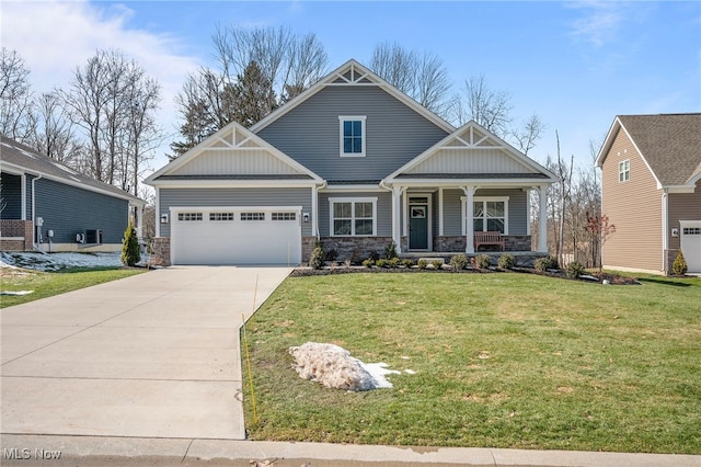 craftsman inspired home featuring covered porch, a garage, driveway, board and batten siding, and a front yard