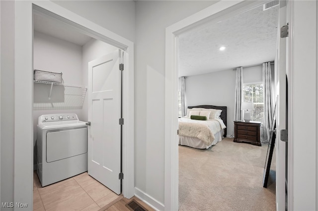 laundry area featuring washer / dryer, visible vents, laundry area, and a textured ceiling