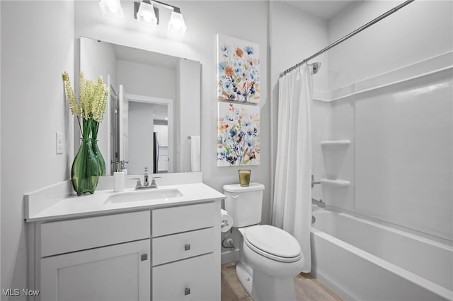 full bath with shower / tub combo, vanity, and toilet