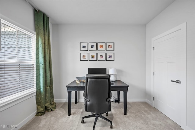 carpeted home office featuring baseboards