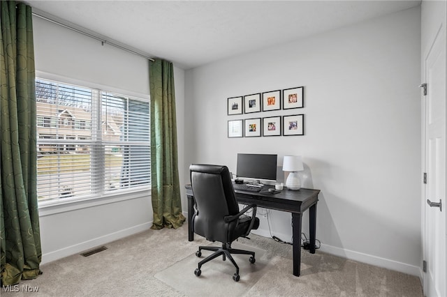 office with carpet, visible vents, baseboards, and a wealth of natural light