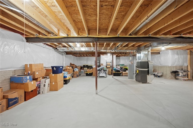 unfinished basement featuring heating unit