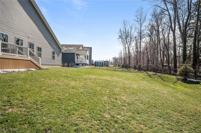 view of yard with fence, stairway, and a wooden deck