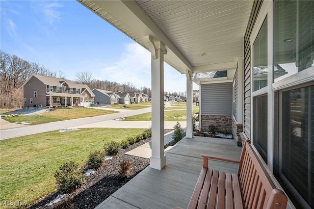 view of patio / terrace with a porch and a residential view