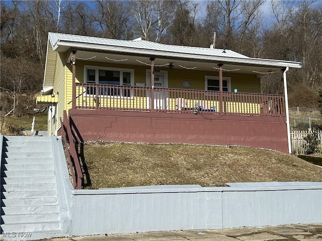 view of front of home with metal roof and a porch