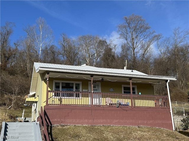 view of front of property featuring covered porch and metal roof