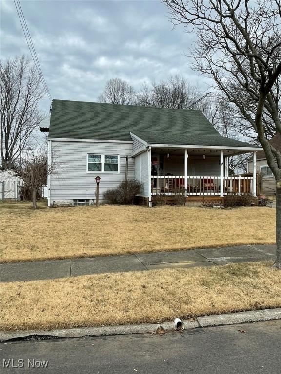 view of front of property with covered porch and roof with shingles