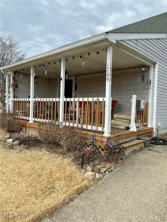 view of property exterior featuring covered porch