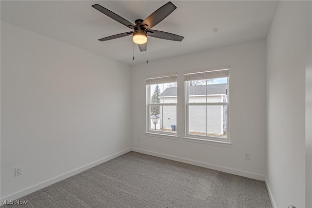 empty room with light carpet, ceiling fan, and baseboards