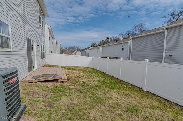 view of yard featuring central air condition unit, a residential view, fence, and a wooden deck