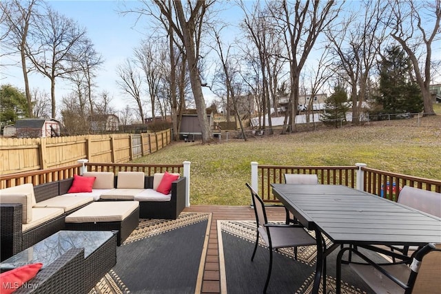 deck featuring outdoor dining area, a yard, outdoor lounge area, a fenced backyard, and an outdoor structure