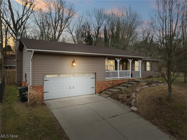 single story home featuring covered porch, a shingled roof, concrete driveway, and brick siding