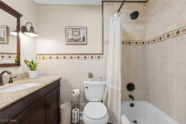 full bath featuring shower / bathtub combination with curtain, tile walls, vanity, and toilet