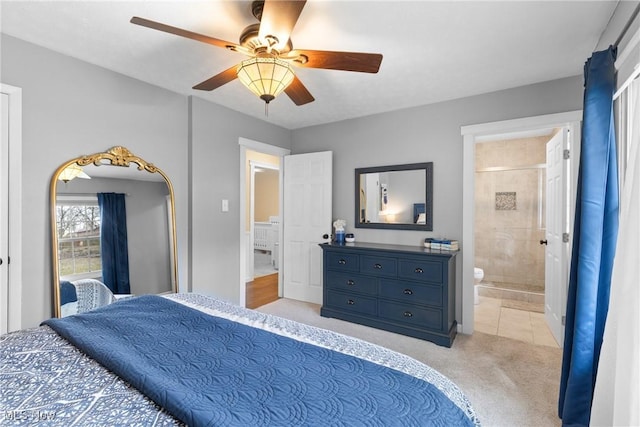 bedroom with ensuite bath, a ceiling fan, and light colored carpet