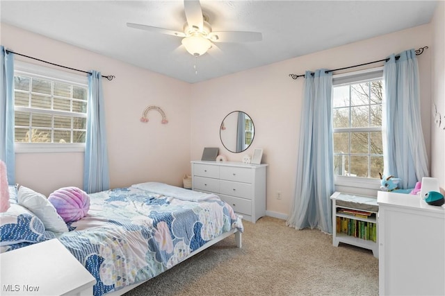 bedroom featuring baseboards, a ceiling fan, and light colored carpet