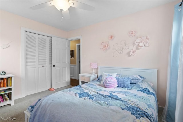 carpeted bedroom with a closet and a ceiling fan