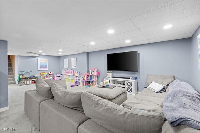 carpeted living room with stairway, a drop ceiling, and recessed lighting