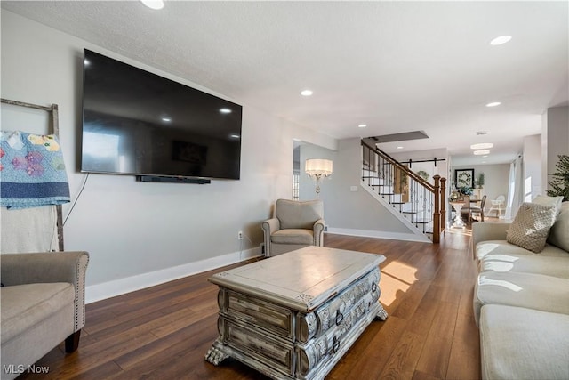 living room with stairs, recessed lighting, wood-type flooring, and baseboards