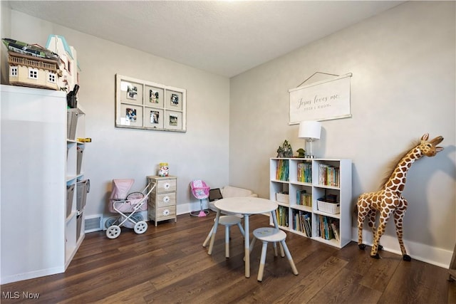 playroom featuring visible vents, baseboards, and wood finished floors