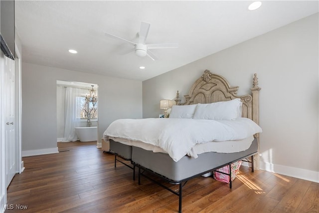 bedroom with baseboards, wood finished floors, and recessed lighting