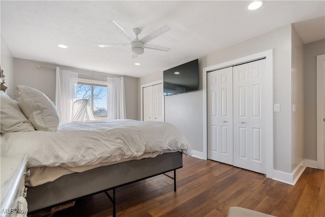 bedroom with ceiling fan, recessed lighting, baseboards, multiple closets, and hardwood / wood-style floors