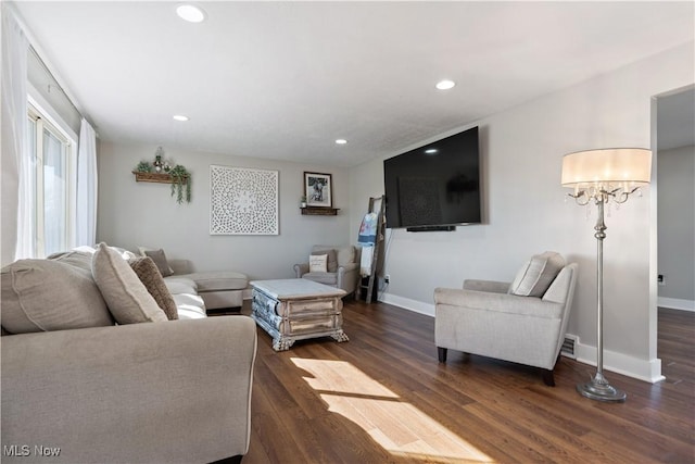 living room featuring baseboards, dark wood finished floors, and recessed lighting