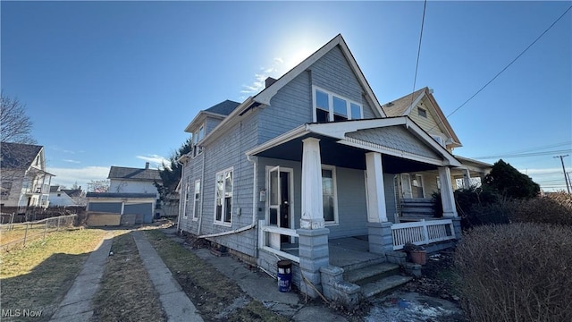 view of front of property featuring covered porch and fence