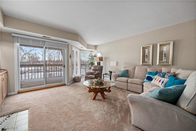 living area featuring light colored carpet and baseboards