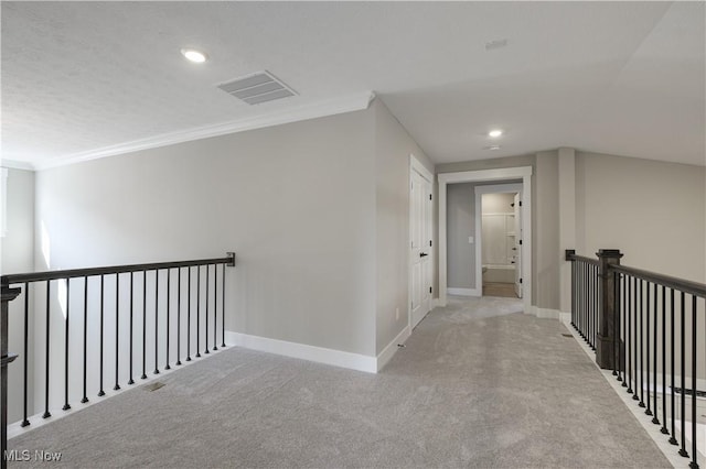 hallway featuring baseboards, visible vents, ornamental molding, carpet floors, and recessed lighting