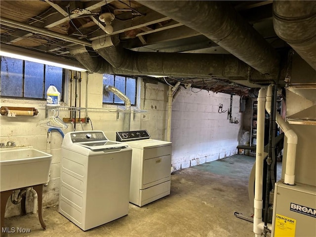 unfinished below grade area featuring separate washer and dryer and a sink