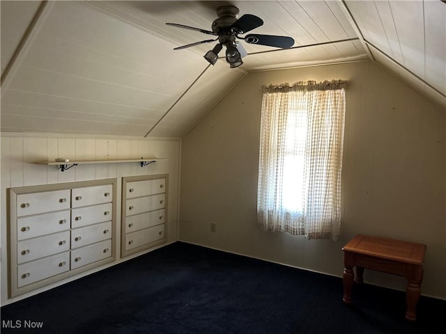 bonus room featuring vaulted ceiling, dark colored carpet, and ceiling fan