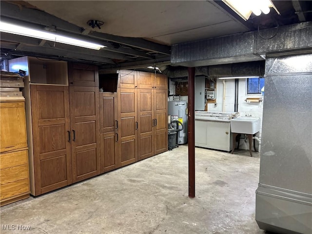 unfinished basement with electric water heater and a sink