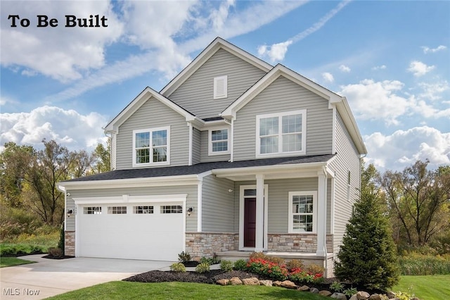 craftsman-style house featuring stone siding, an attached garage, and concrete driveway