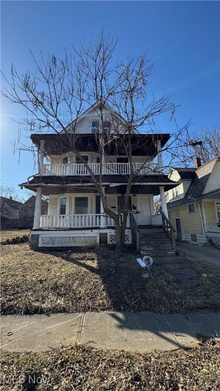 view of front of home with a balcony and covered porch