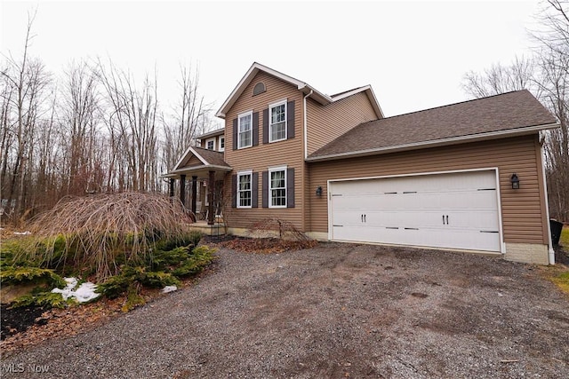 traditional-style house with an attached garage and dirt driveway