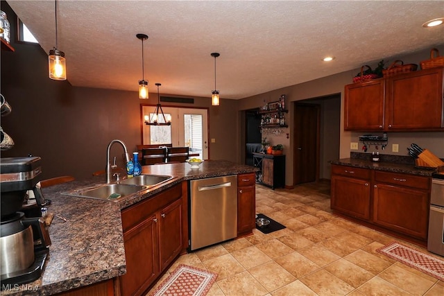 kitchen with stainless steel dishwasher, dark countertops, a sink, and decorative light fixtures