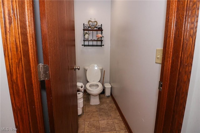 bathroom featuring baseboards, toilet, and tile patterned floors