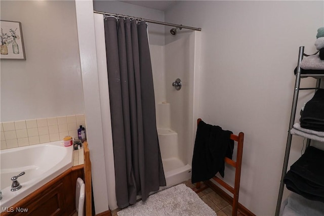 bathroom featuring tile patterned flooring and a shower stall