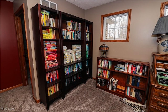 living area with carpet flooring and baseboards