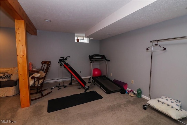 exercise area with a textured ceiling, a baseboard radiator, carpet flooring, and baseboards