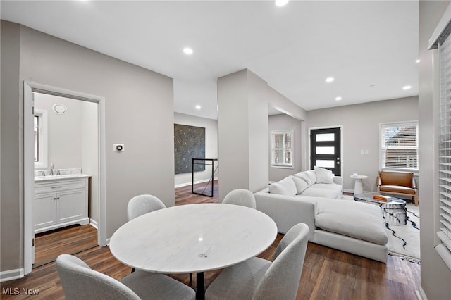 dining space featuring baseboards, dark wood finished floors, and recessed lighting