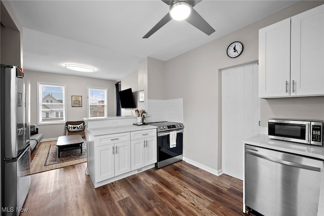 kitchen with white cabinets, stainless steel appliances, and dark wood finished floors